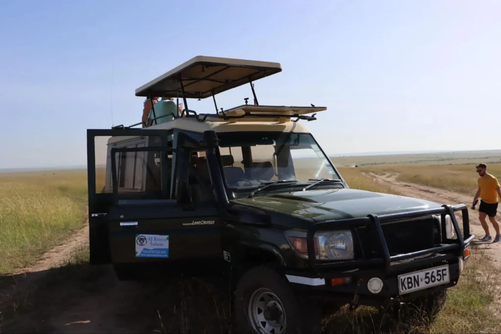 A 4x4 Land Cruiser parked on the plains for a sundowner safari masai mara.