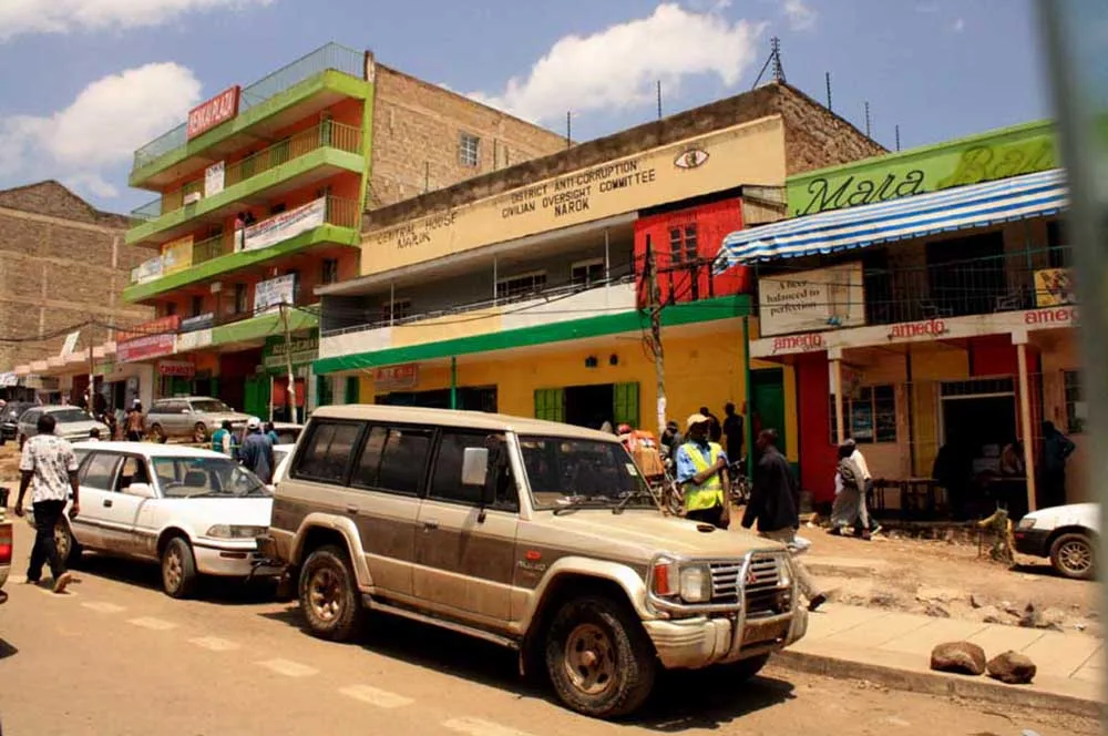 A dusty 4x4 vehicle parked in Narok town following key masai mara travel tips.