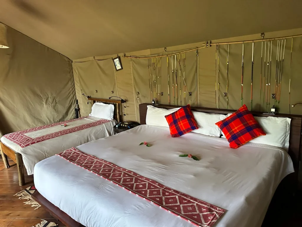 Interior of a luxury safari tent at Basecamp Masai Mara featuring comfortable beds.