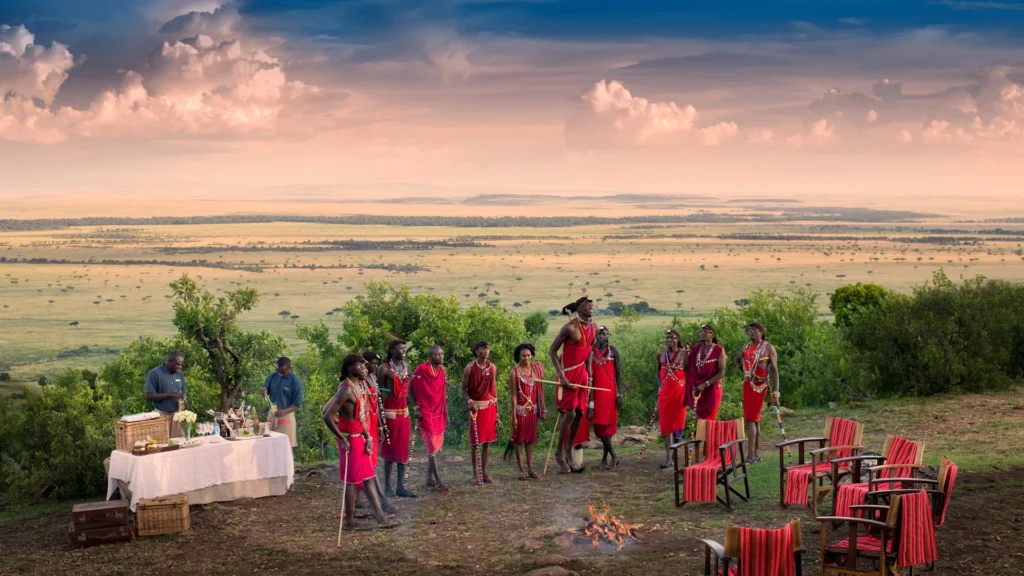 Traditional Maasai dance performance during a scenic bush sundowner at Bateleur Camp Masai Mara.